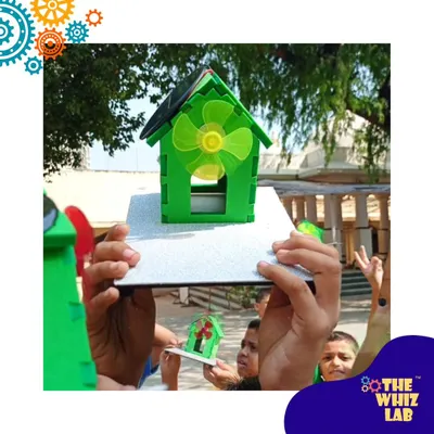 Harnessing the power of the sun! Students at New Activity School in Mumbai hold up the solar-powered fan houses they built. This was a perfect outdoor session to learn about renewable energy.