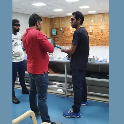 I believe in hands on coaching. Here, I'm discussing shot patterns and technique with a student right after his practice, providing immediate and actionable feedback.