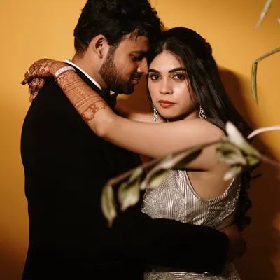 An intimate embrace against a bold yellow backdrop. This shot showcases our use of color and dramatic lighting to create a modern, high-fashion look.