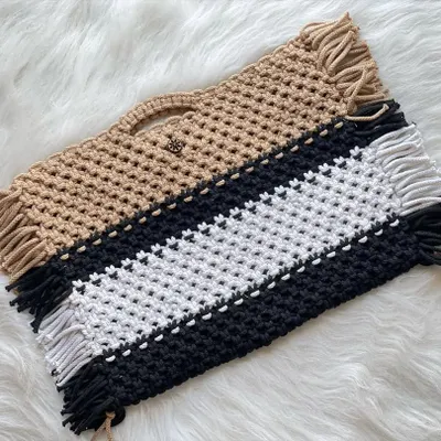 My macrame laptop bags are a new and popular item. They are fully handmade and can be customized in any color, like these tan and black-and-white versions.