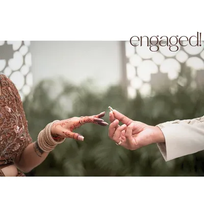 The moment the ring slides onto her finger, sealing their engagement. The intricate henna and traditional attire add a rich cultural context to this beautiful detail shot from a shoot in Agra.