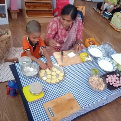 Our parent community is an integral part of our school. Here, a mother and child work together to prepare a snack. These sessions are a wonderful way for parents to get involved and share their own healthy recipes.