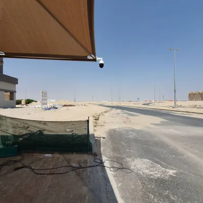 A Tiandy PTZ camera installed in Wafra, overlooking a long road. The high mounting point gives a wide, unobstructed view of the area.