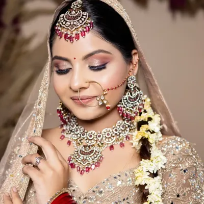 A soft, romantic bridal look with shimmering pink eyeshadow and a classic red bindi. This is a perfect example of the detailed work my students learn to create for their portfolios.