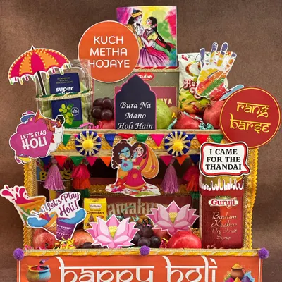 Bringing a *rangeen* blast to your Holi celebrations! This hamper is designed to look like a vibrant street stall, packed with fresh fruits, thandai, gujia, and fun props like water guns and colors to get the party started.