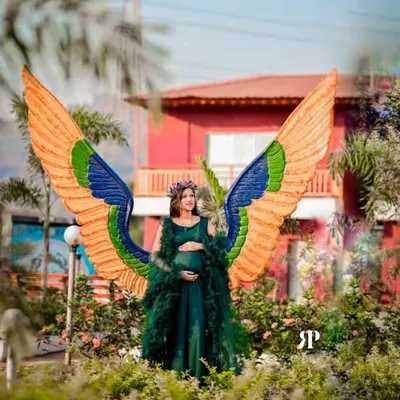 This is one of my absolute favorite pieces for a truly magical maternity photoshoot. The emerald green gown comes with a dramatic feathered overlay and these stunning, colorful angel wings to create a one-of-a-kind look. It’s perfect for mamas who want to feel like a goddess.