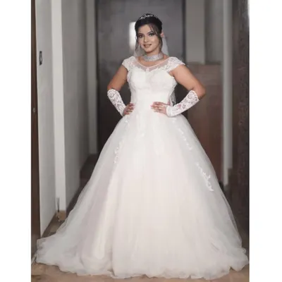 I also provide classic white wedding gowns for Christian ceremonies. This beautiful ball gown features an off-shoulder lace bodice, a full tulle skirt, and comes with matching lace gloves for a complete look.