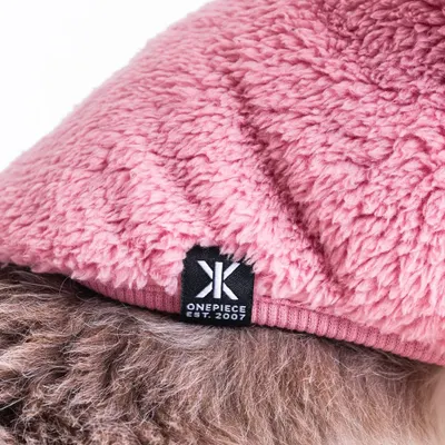 For e-commerce, detail shots are crucial. This close-up of the OnePiece logo on a pet sweater shows the product's quality and branding, helping customers make an informed purchase.