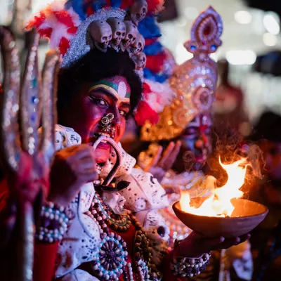 A powerful close-up of an artist portraying the goddess Kali. I focused on the intense expression and the dramatic fire element to capture the raw energy of the performance.