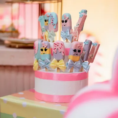 Adorable and delicious. These custom-made cakesicles were designed to match a Candyland theme, complete with pastel colors and tiny bows.