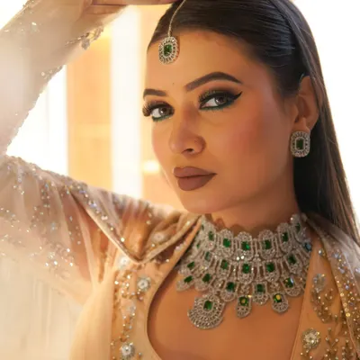 A bold and dramatic look from my Riwayat collection. I created this sharp, emerald green winged eyeliner and paired it with a matte nude lip to complement the stunning traditional jewelry, perfect for a sangeet or wedding guest.
