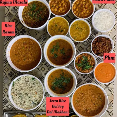 A look at a large meal prep for a get together and for dehydration. The spread includes BisiBile Bath, Rajma Masala, Dal Makhani, Pav Bhaji, and more, all made fresh.