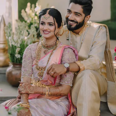 A perfect portrait of two doctors in love, their smiles reflecting a shared journey. This image captures the elegance of their traditional South Indian wedding attire and the easy comfort they find in each other.