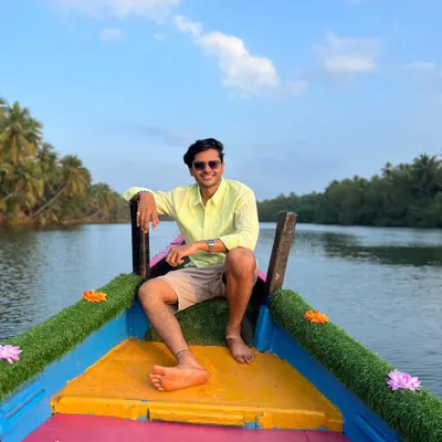 A traveler enjoying the scenic boat ride through the mangrove forest in Honnavara.