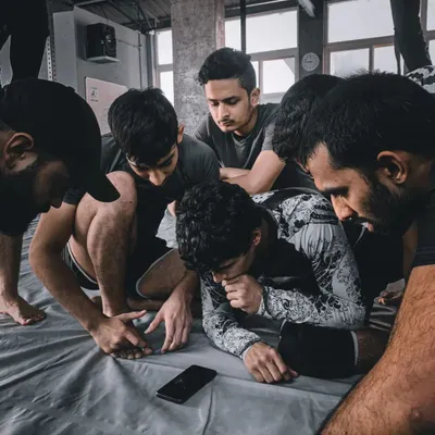 Jiu-Jitsu is a deliberate and detailed study. Here, our students are gathered around a phone, breaking down footage from a roll. This is the intellectual curiosity we foster.