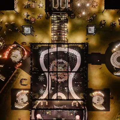 An aerial view of the musical-themed reception, showing the grand layout with the piano-key dance floor as the central element. The entire design was a symphony of patterns and light.