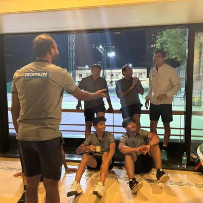 The best conversations happen off the court. Here, our coach engages with the team in a relaxed setting, fostering a comfortable environment where everyone can connect on a personal level.