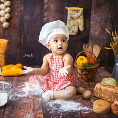 What's cooking, little one? The flour-covered hands and face are the best part of my baby chef sessions. I love capturing these moments of playful discovery in my rustic kitchen setup.