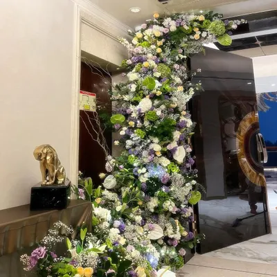 I get so excited about large installations because that's where the magic happens. This floral wave was designed to grow organically around a doorway, creating a statement of abundance and welcoming guests with a burst of natural beauty.