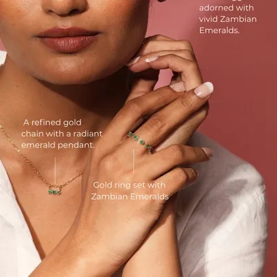 The Petit Emerald Set is the definition of understated elegance. This image shows the complete set worn together: a refined gold chain with an emerald pendant, matching gold huggies, and a delicate ring.