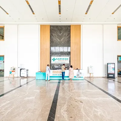 The main reception at Sarvesh Health City in Hisar features a double-height ceiling and clean lines to create a sense of calm and order. The design prioritizes clear wayfinding to reduce visitor anxiety from the moment of entry.