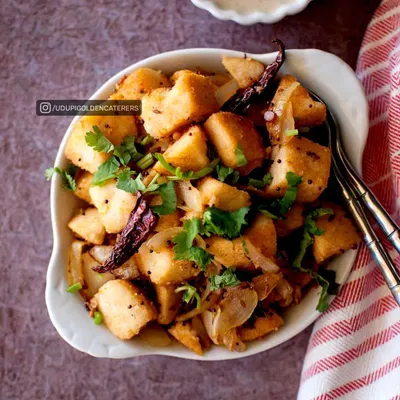 Our Masala Idli Fry is a delicious and savory breakfast option. We take soft, steamed idlis, cut them into cubes, and sauté them with onions, mustard seeds, and aromatic spices for a flavorful twist.