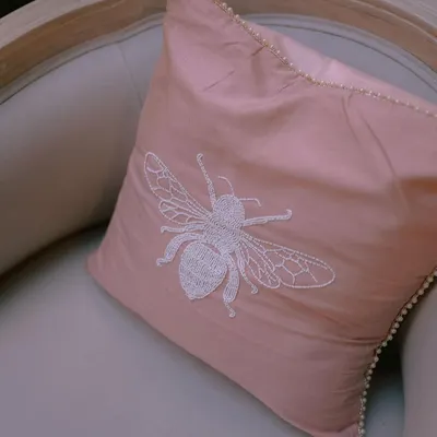 Details make the difference. For one wedding, we created custom upholstery with this beautiful hand-embroidered bee motif, adding a personal and whimsical touch to the decor.
