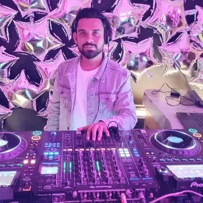 Behind the decks at a private celebration. I cater to all types of events, from birthdays to anniversaries, with a custom music set.