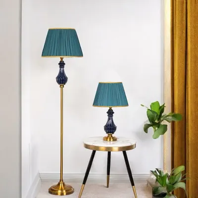 This matching set features a deep navy ceramic base with a pleated teal shade, creating a rich, jewel-toned look. Using the floor and table lamp together in one room provides layered lighting and a sophisticated, unified aesthetic.