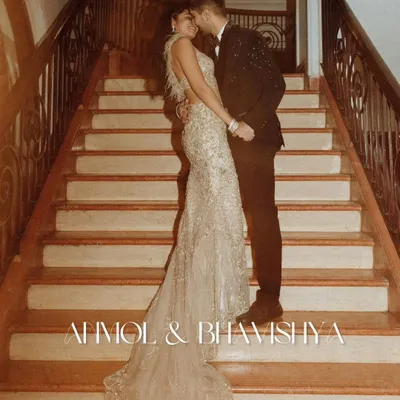 Anmol and Bhavishya's pre-wedding portrait on this grand staircase is a perfect example of editorial elegance. The sweeping train of the gown and the intimate pose create a powerful, romantic statement.