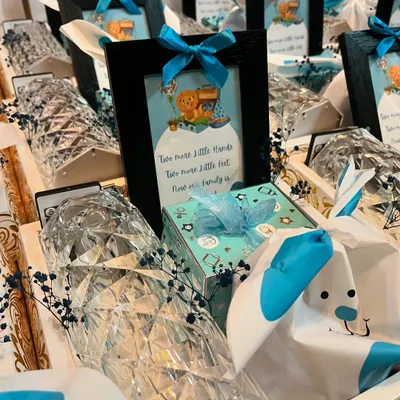 A closer look at the details of my "It's a Boy" baby announcement hampers. Each gift includes a small framed picture, a diamond-cut lamp, and other beautifully wrapped goodies.