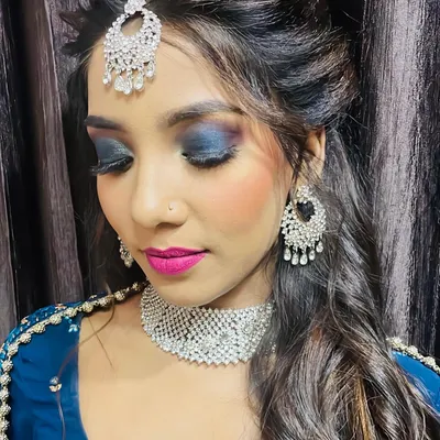This is a complete reception makeup look I created for a client. The style features a dramatic blue smokey eye balanced with a bold pink lip, complemented by elegant hairstyling and traditional jewelry. My goal for any event makeup is to create a stunning, memorable look that lasts all night.