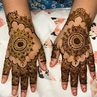 A classic and bold mandala design on the back of the hands. The symmetrical pattern is perfectly centered, creating a stunning and powerful look that is always in style.