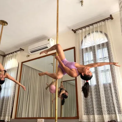 Trying to keep my facial expression in check while holding a challenging pose. Pole fitness requires immense strength, focus, and a bit of grace under pressure.