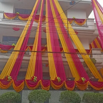 A full house decoration with bright pink and yellow drapes. I can cover the entire facade of the building to give it a completely festive and celebratory look for the wedding week.
