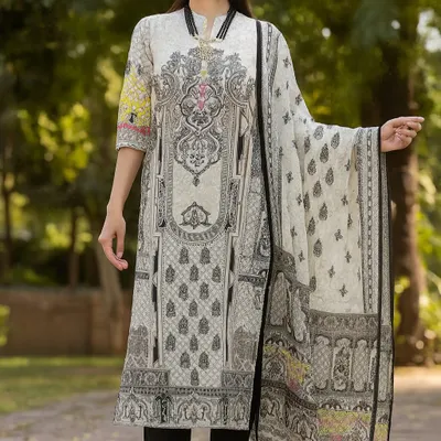You can never go wrong with a classic black and white printed suit. This set features a straight-cut kurta with an intricate, architectural print and comes with a light, matching dupatta finished with playful tassels. It's a sophisticated look that is perfect for the office or a semi-formal dinner.