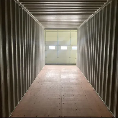 The interior of a fresh container, showcasing the clean wooden floor and corrugated steel walls. This provides a strong, reliable, and weatherproof shell that we transform into your ideal space.