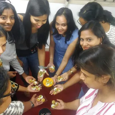 A circle of creativity! Participants in a miniature workshop show off the tiny, detailed pieces they made together.