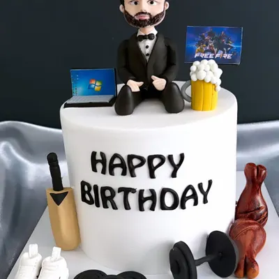 How well do you know your husband's hobbies? This cake tells a whole story, with edible toppers representing everything he loves: cricket, fitness, gaming, and work.