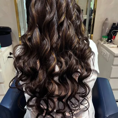 A perfect example of a chocolate brown base with caramel highlights. I styled the hair in deep, glossy curls to show off the dimension and shine of the new colour.