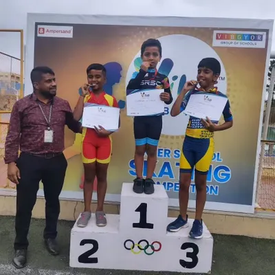 A picture of pure joy and achievement. Our coach stands proudly with our skaters as they dominate the podium at the VIBGYOR Group of Schools inter-school skating competition.