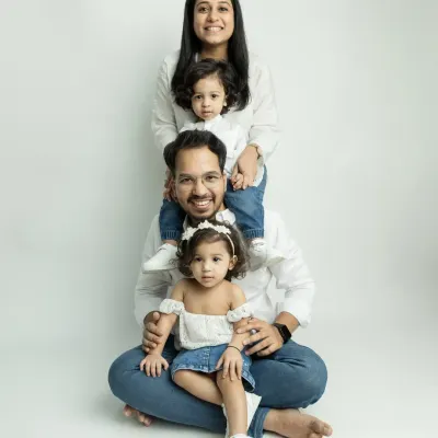 A fun and creative family pose! This stacked portrait is a playful way to capture the whole family together.