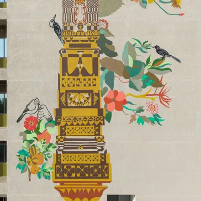 A close-up of the 'Tower of Harmony' mural, showcasing the intricate details inspired by local textiles, temple carvings, and architectural ornamentation of Gujarat. Native birds and flora are woven into the design, symbolizing the connection between nature and civilization.