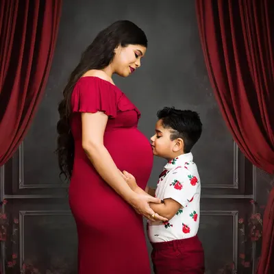 Welcoming a new baby is a family affair. I love capturing moments like this, where an older sibling connects with the baby bump. It’s a beautiful way to document your family's growing love story.