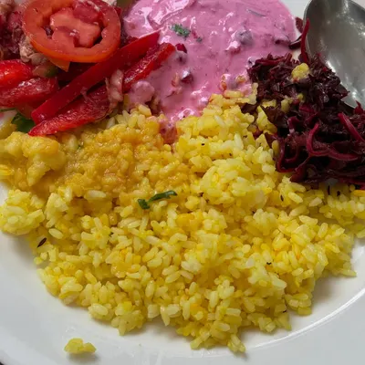 A plate full of color and life. This is what nourishment looks like at my retreats: vibrant beetroot raita, fresh salads, and flavorful rice, all designed to be as delicious as it is healthy.