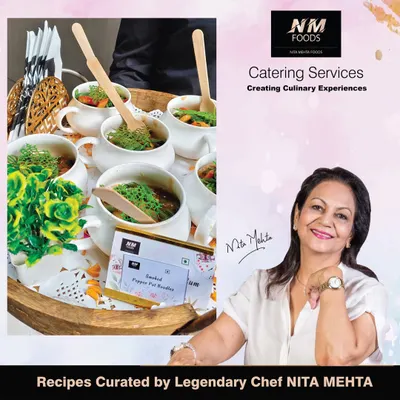 Every menu we create is backed by the expertise of the legendary Chef Nita Mehta. This image shows her alongside our Smoked Pepper Pot Noodles, a dish curated from one of her signature recipes.