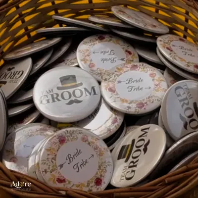 Fun 'Team Groom' and 'Bride Tribe' badges for guests. These little details are a great way to get everyone involved and add a playful element to the wedding festivities.