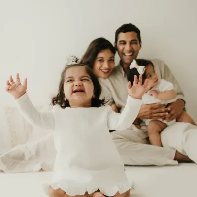 A moment of pure, chaotic joy with twin girls and their parents. This lifestyle family session captures the fun and energy of life with toddlers.
