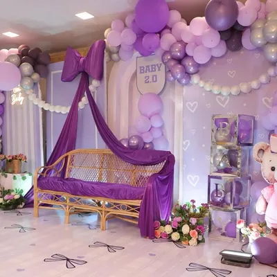 A dreamy baby shower with a purple bow theme. I used cascading drapes, a beautiful rattan sofa, and a giant teddy bear to create a soft and elegant space for the mom-to-be.