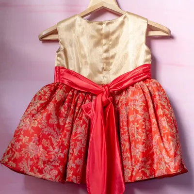 This dress is a beautiful example of fusion wear. I used a traditional red and gold brocade fabric for the skirt and paired it with a simple gold satin bodice, finished with a vibrant coral sash.